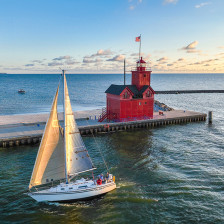Sailboat passing Holland Harbor Light near Holland, Michigan