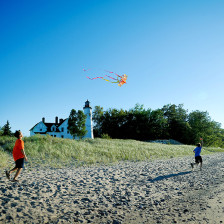 Children playing with a kite at Point Iroquois near Sault Ste. Marie, Michigan