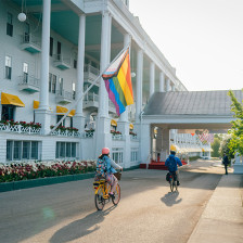 Bikers passing along the Grand Hotel on Mackinac Island, Michigan