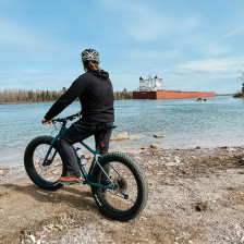 A biker watching a freighter come in at Rotary Island Park near Sault Ste. Marie, Michigan
