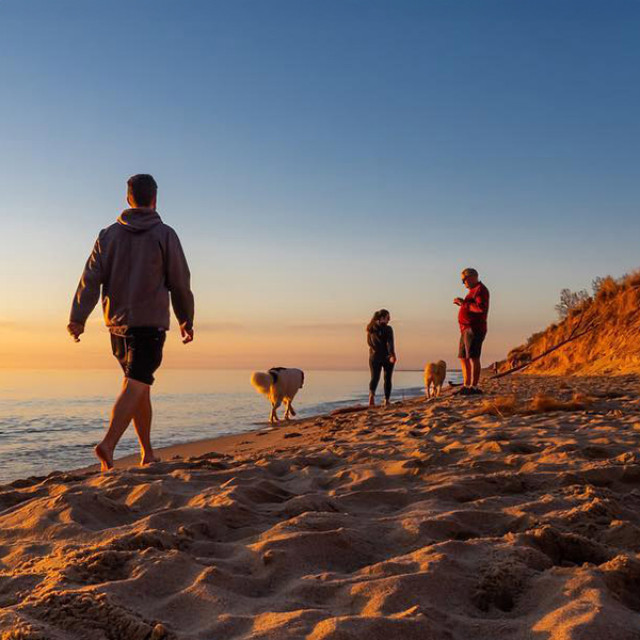 Visitors enjoying the sunset on Lake Michigan near Holland, Michigan