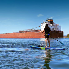 Paddleboarder in the St. Marys River near Sault Ste. Marie, Michigan